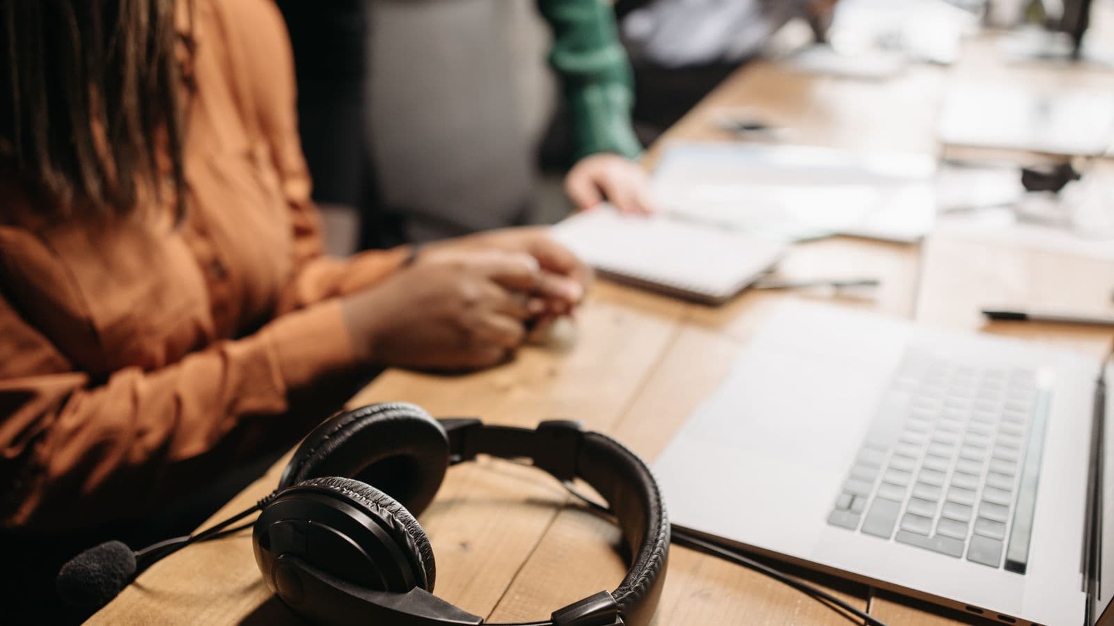 A laptop and headphones on a desk